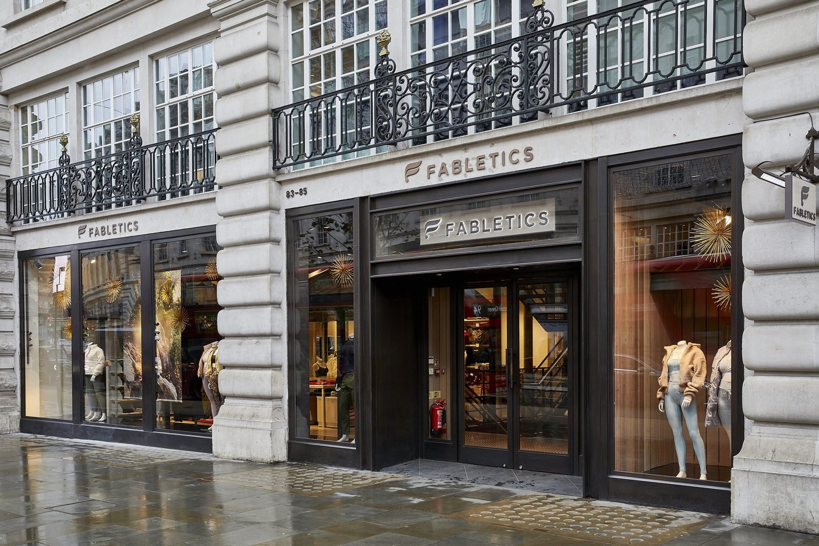 Fabletics storefront on a rainy city street