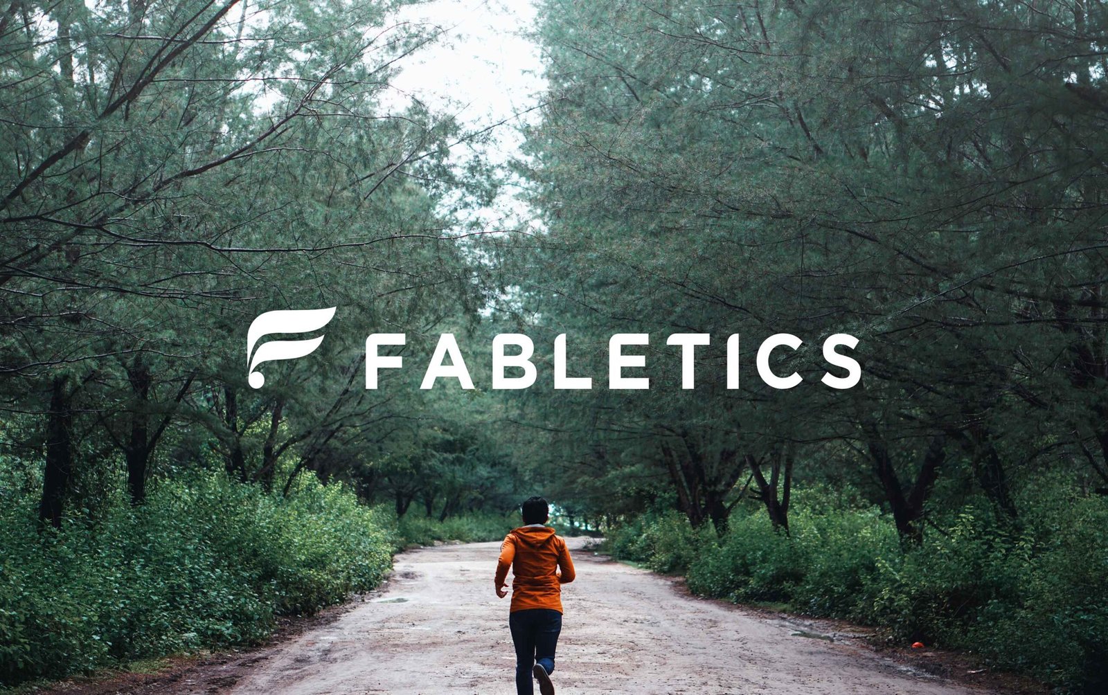 Person running in forest with Fabletics logo
