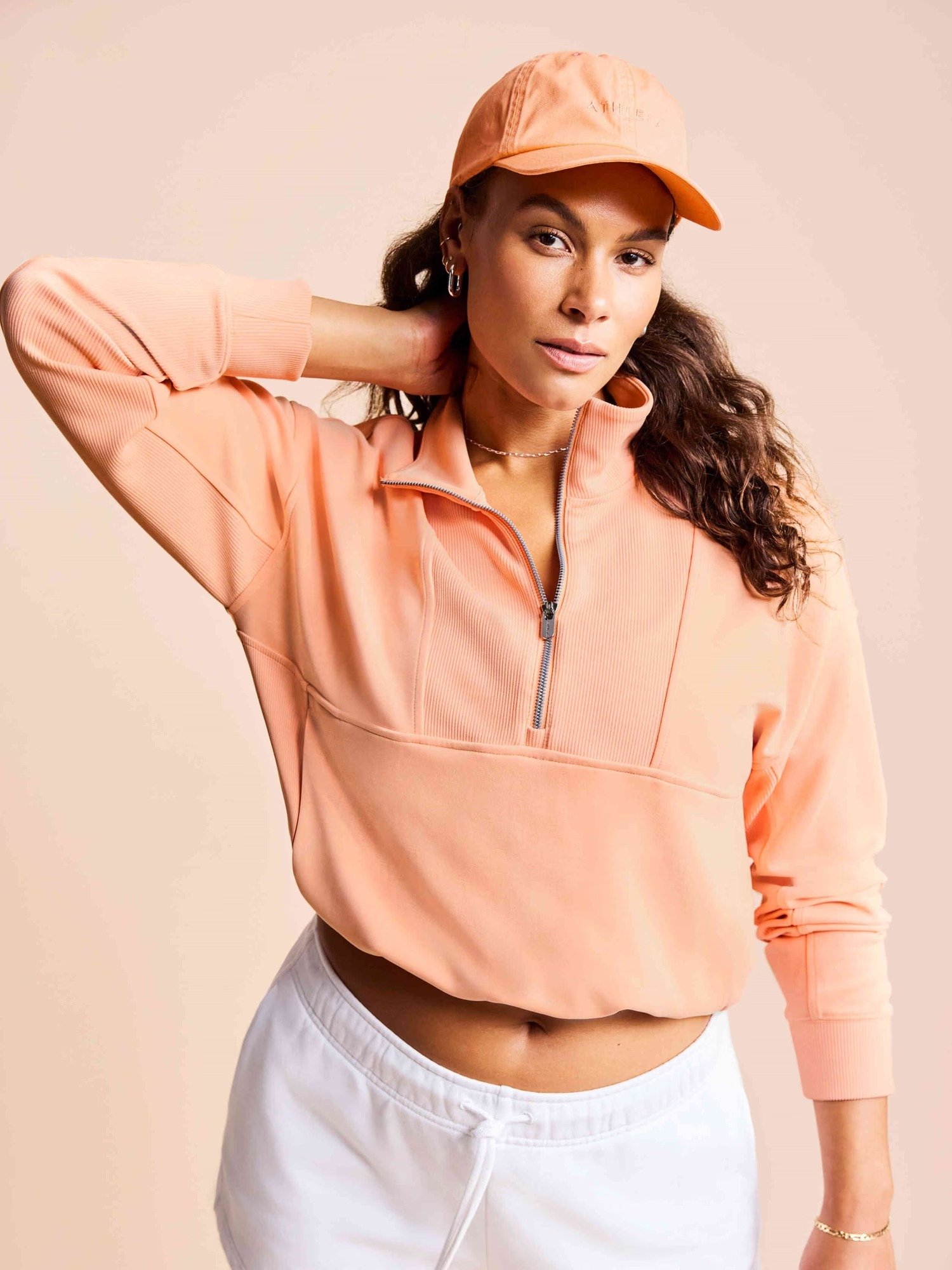 Peach zip pullover with white shorts